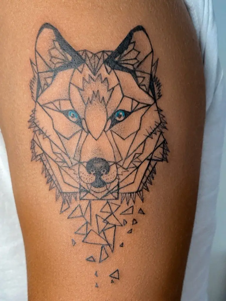 a tattoo of a wolf on a person's arm